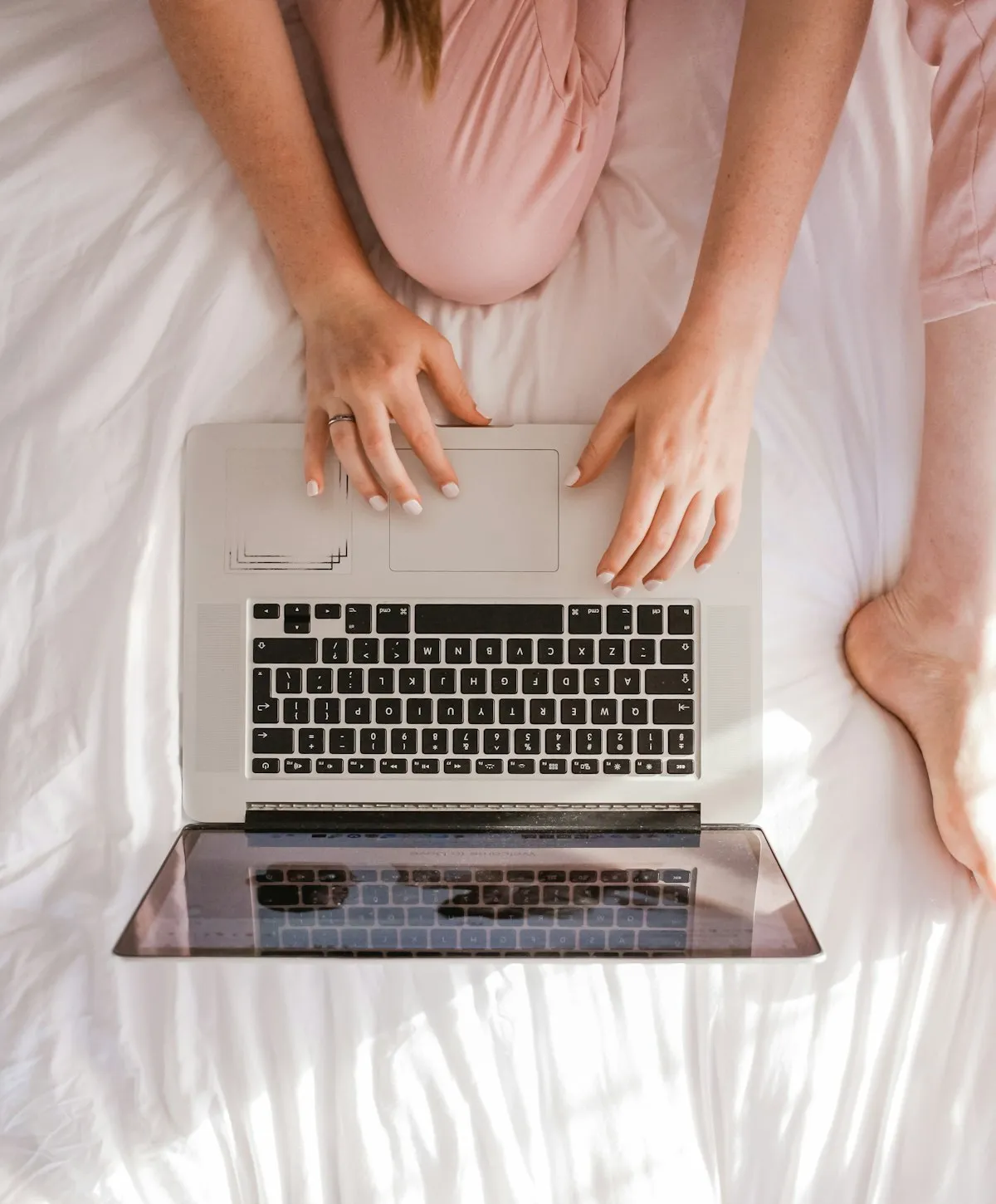 Hands working with a laptop and connected technology