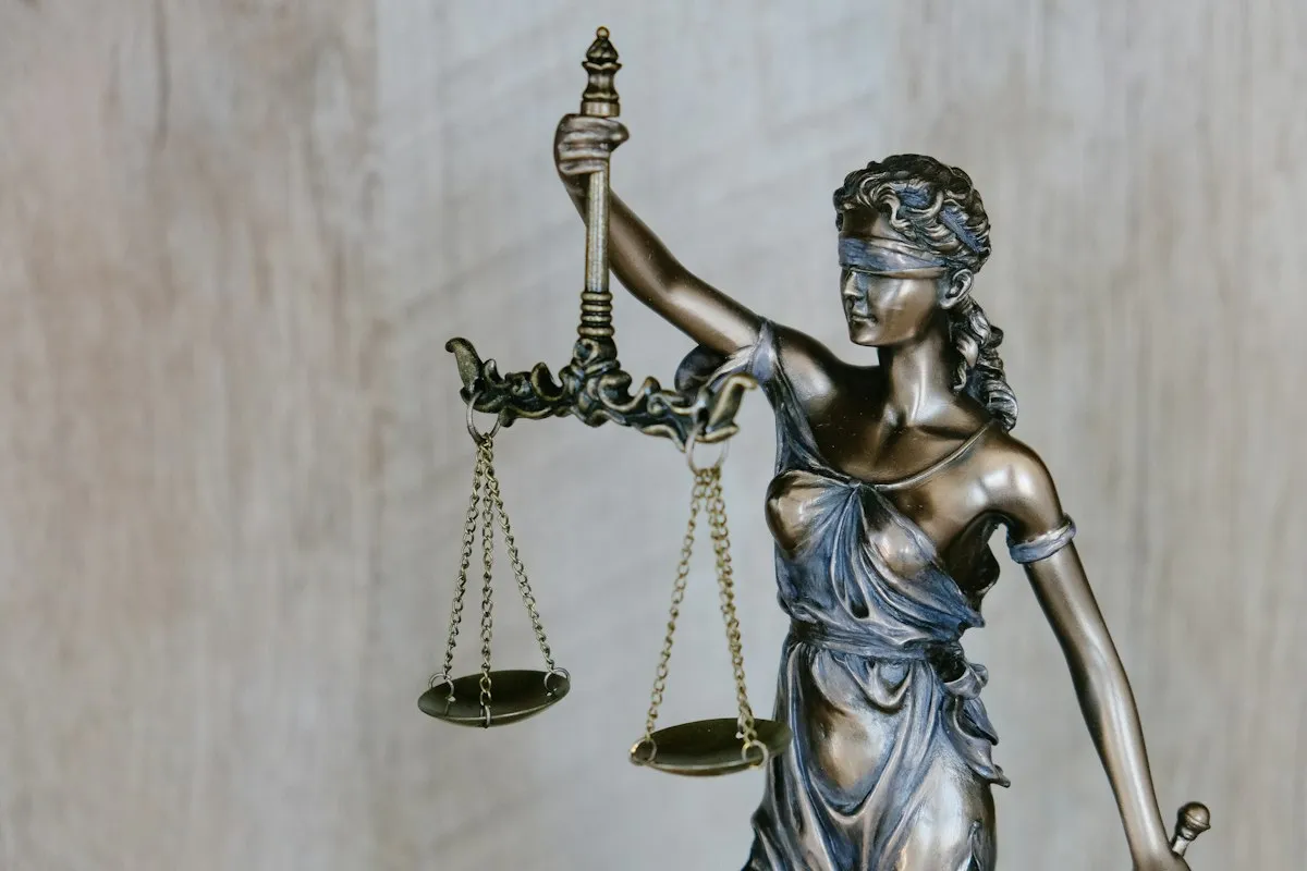 Bronze Lady Justice statue holding balanced scales