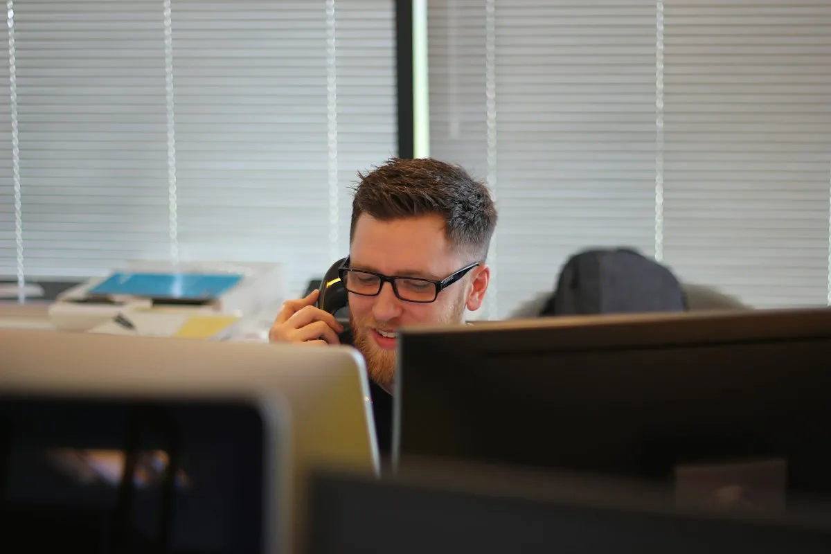 Security analyst working at multiple monitors in an operations workspace