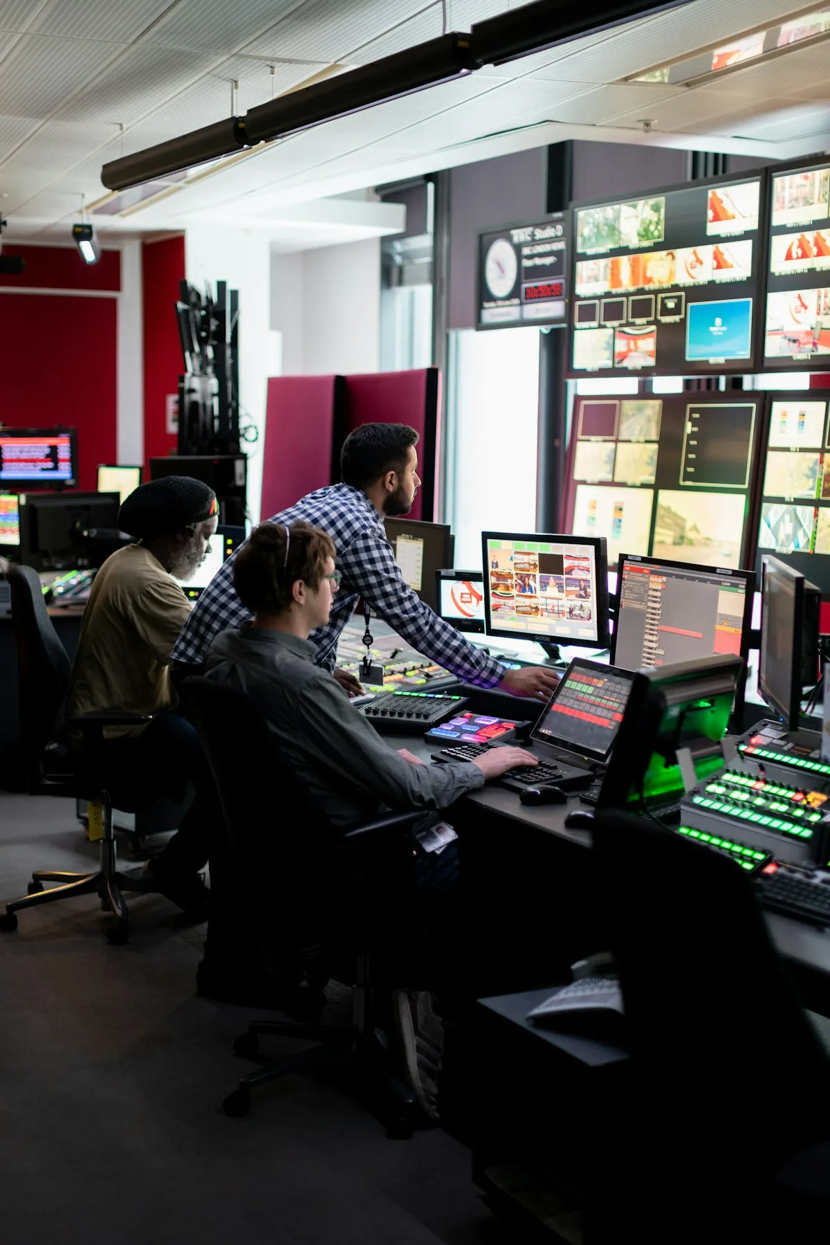 Operators working at consoles in a technology control room