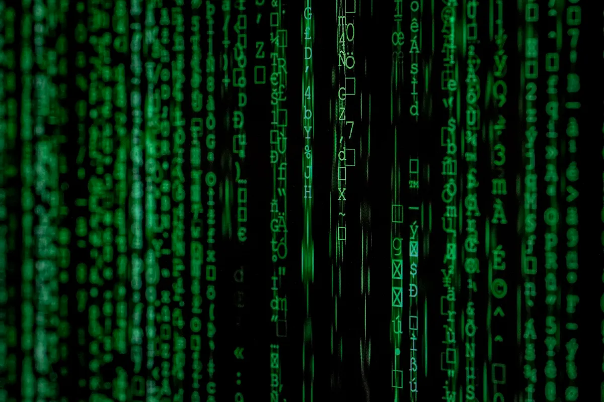Green code and data streams on a dark monitoring display